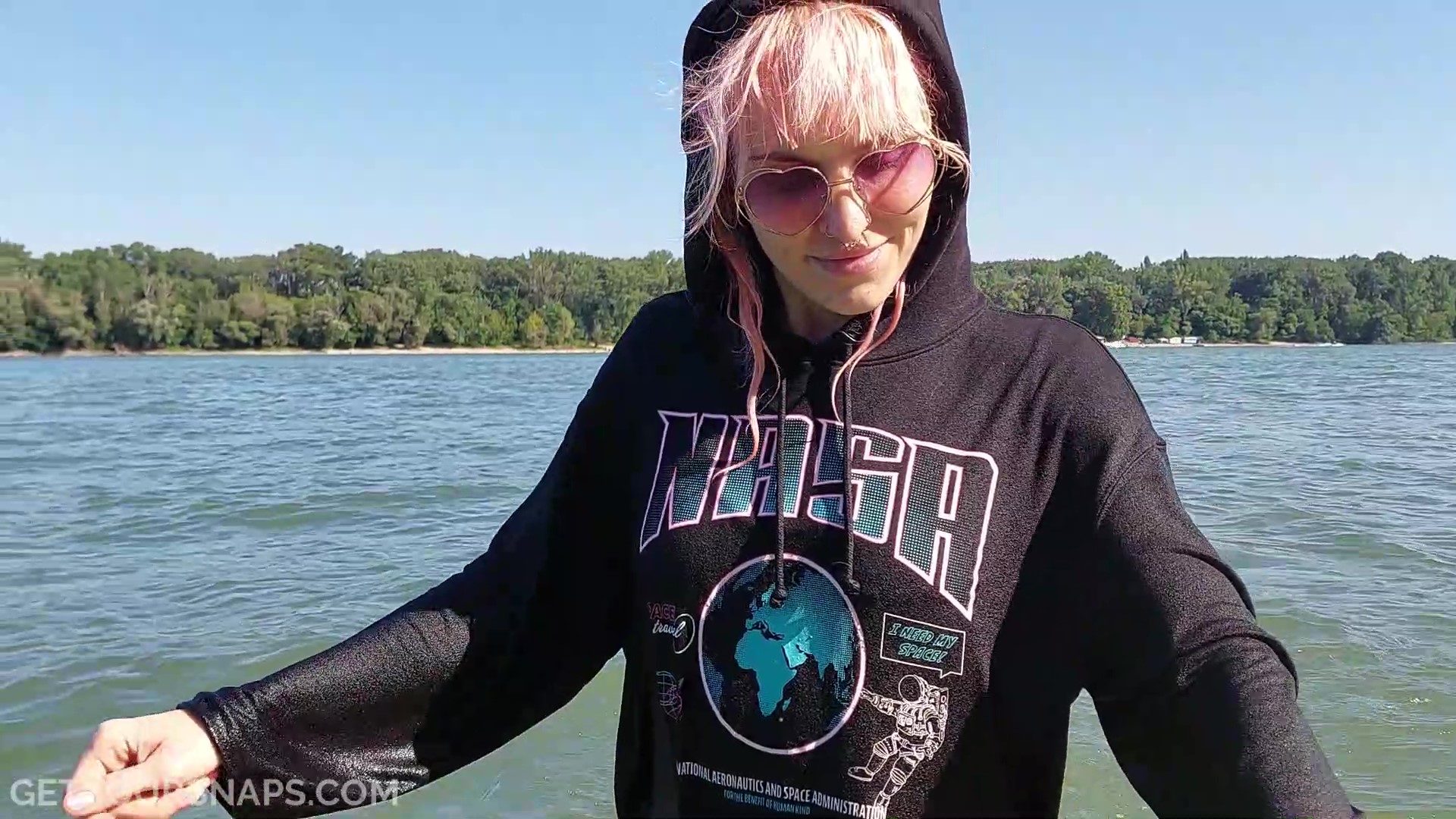 Pinkie takes a bath in the river in jeans, converse and hoodie - frame at 4m51s