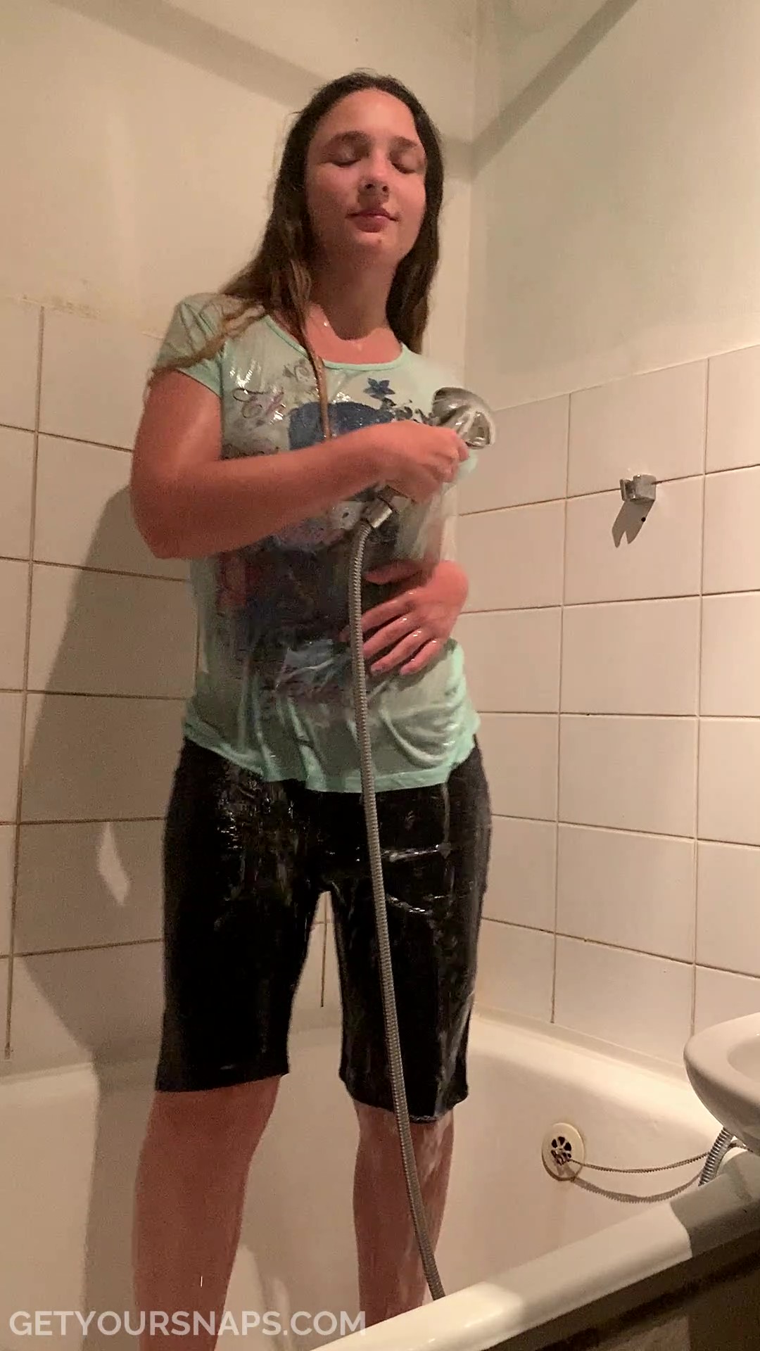 Violet takes a shower in clothed again - frame at 3m39s