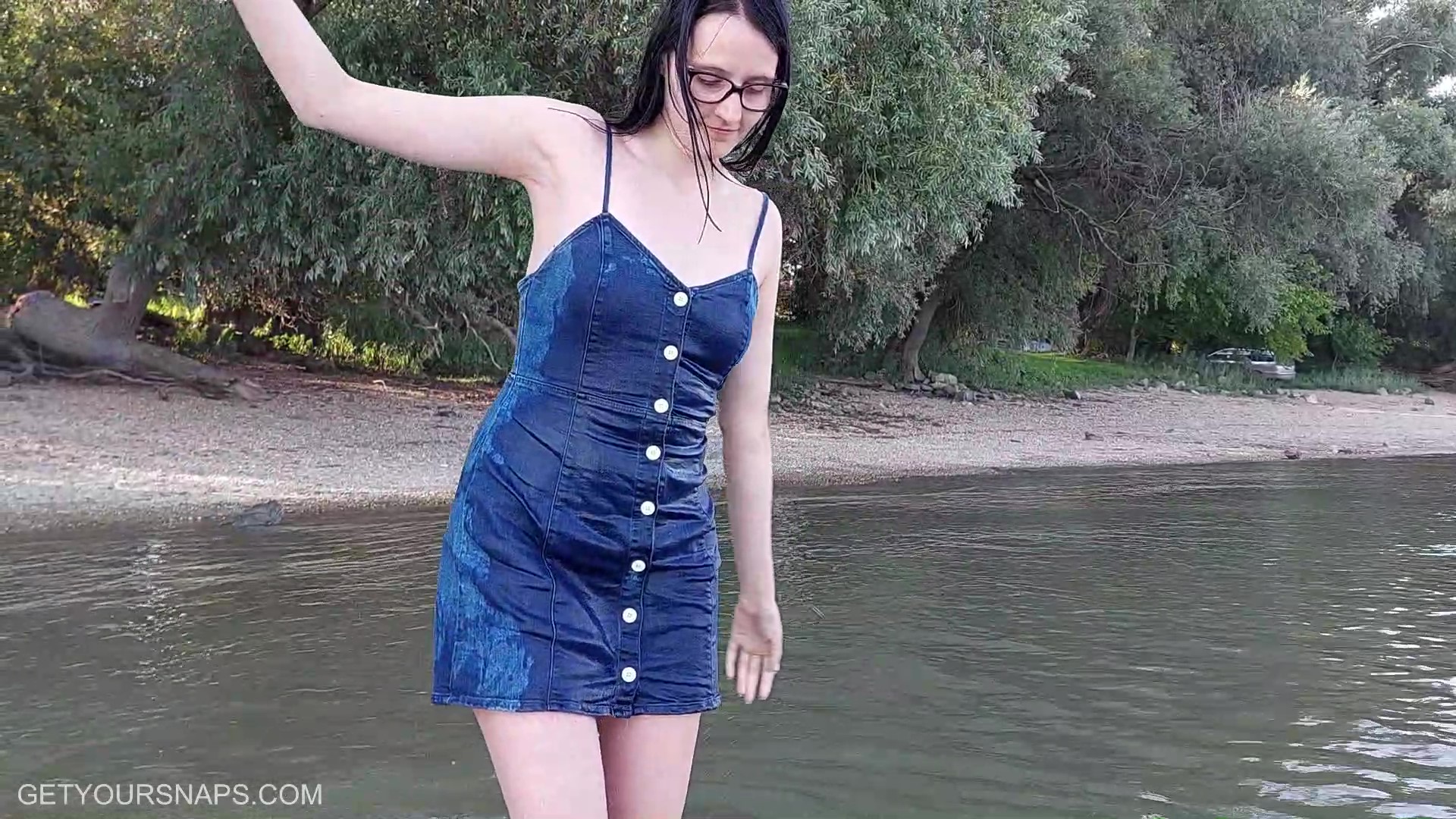 Emily gets wet in denim dress in the river - frame at 1m24s