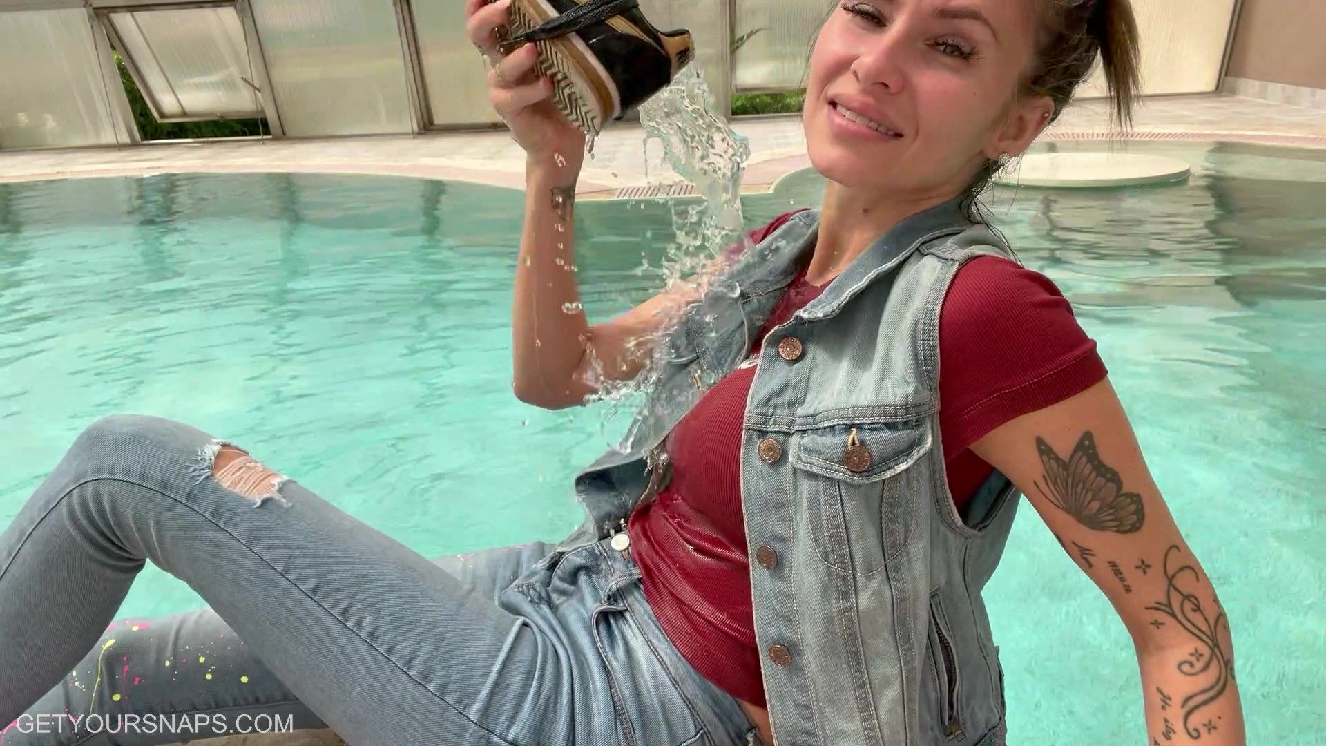 Olga gets wet in the pool in jeans - frame at 8m8s