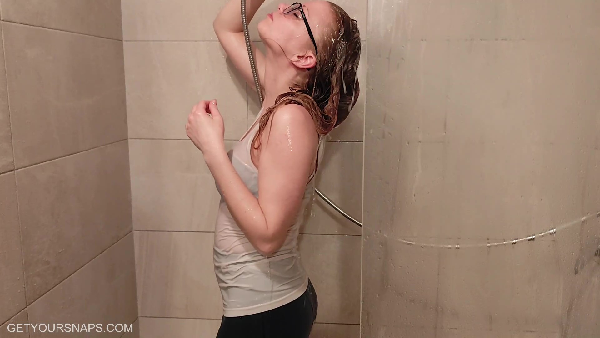 Sarah gets wet in white top and green leatherlook leggings - frame at 7m9s