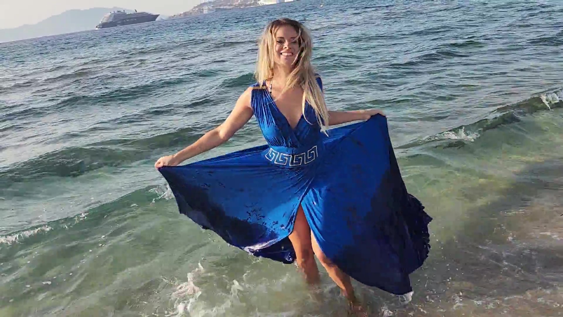 Bella goes swimming in the sea in her blue dress - Image 5