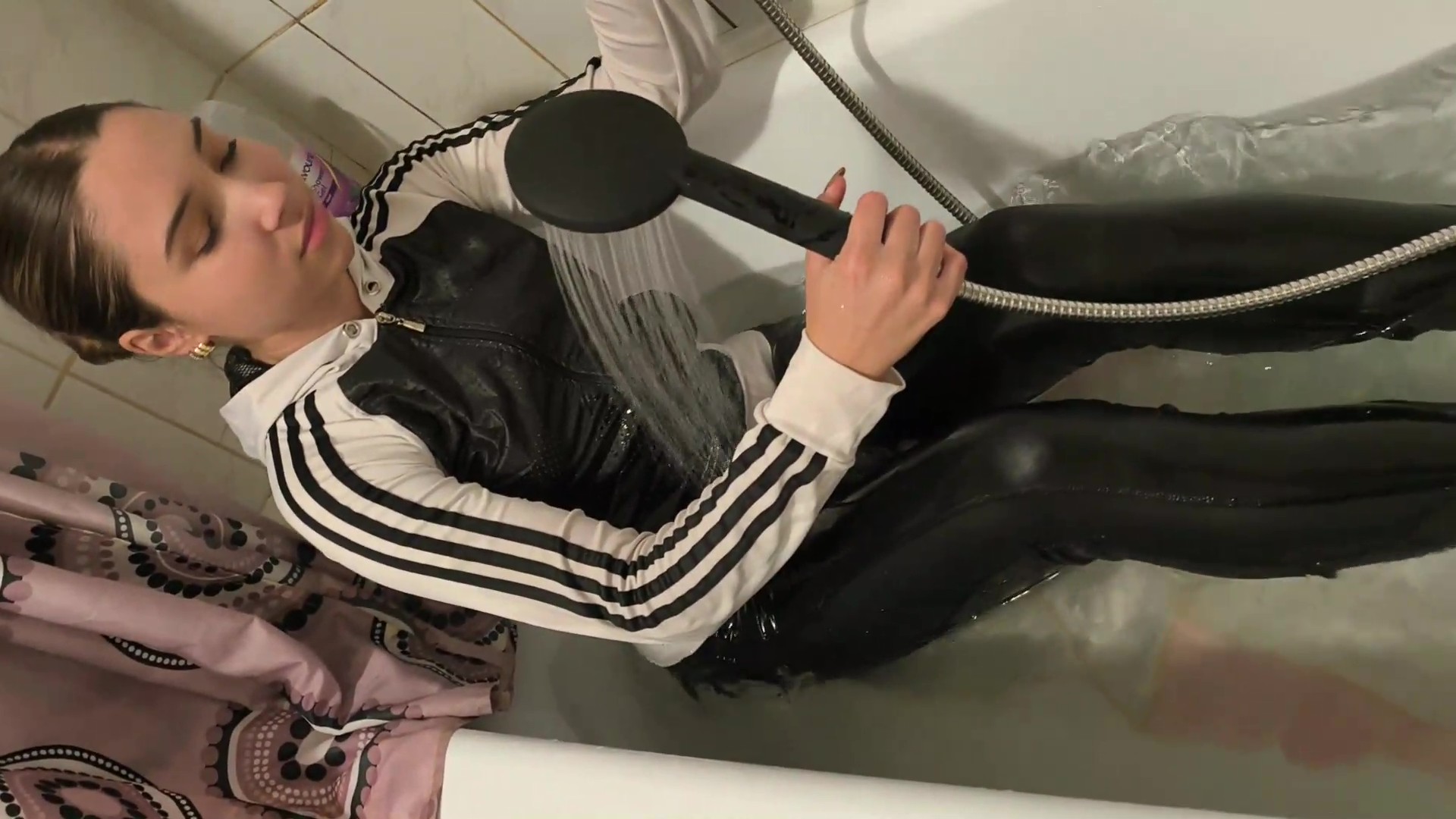 Ellie takes a bath in shiny leggings and a B&W Adidas sweater - Image 5