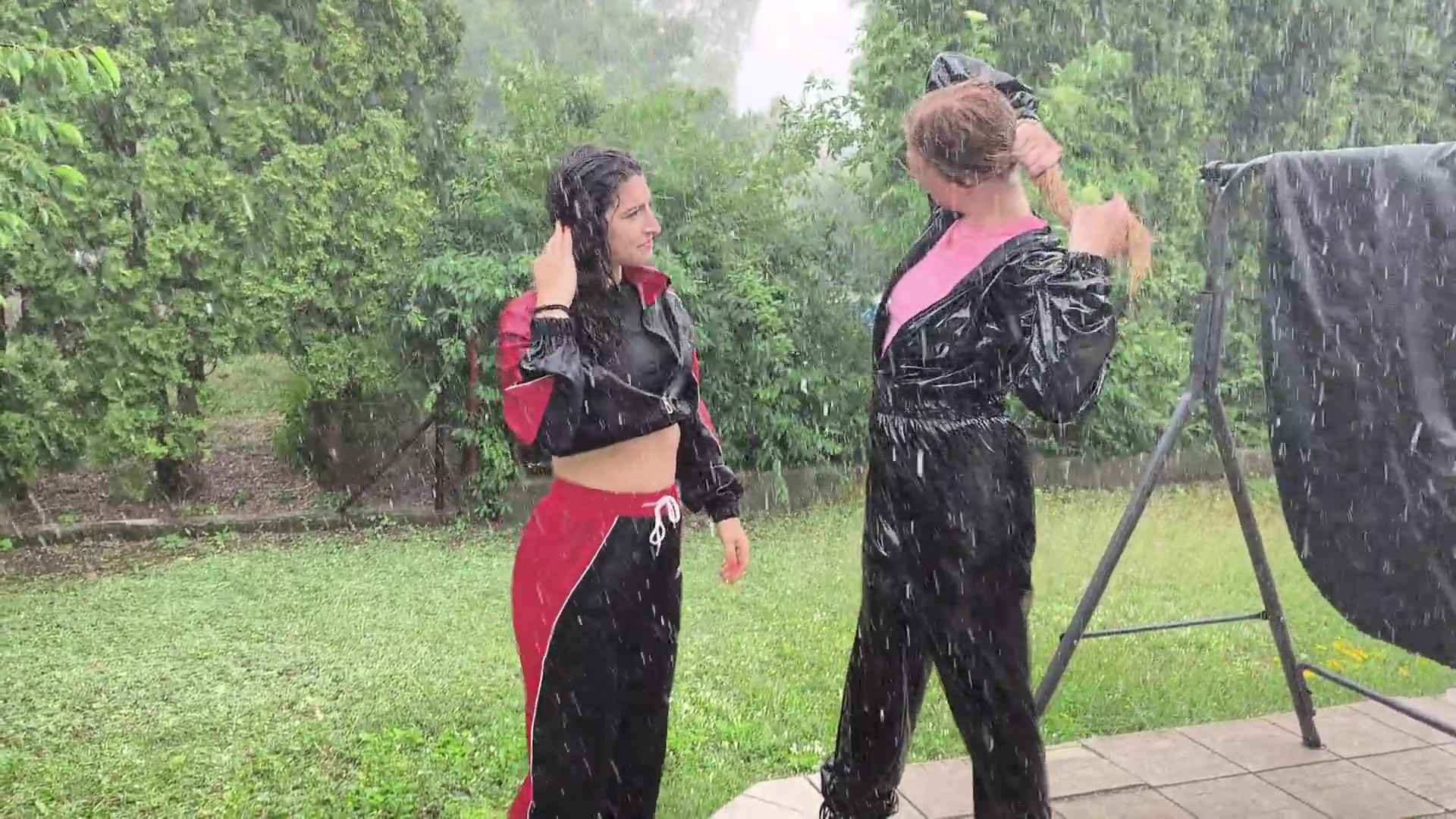 Two girls get very wet in the pouring rain - Image 4