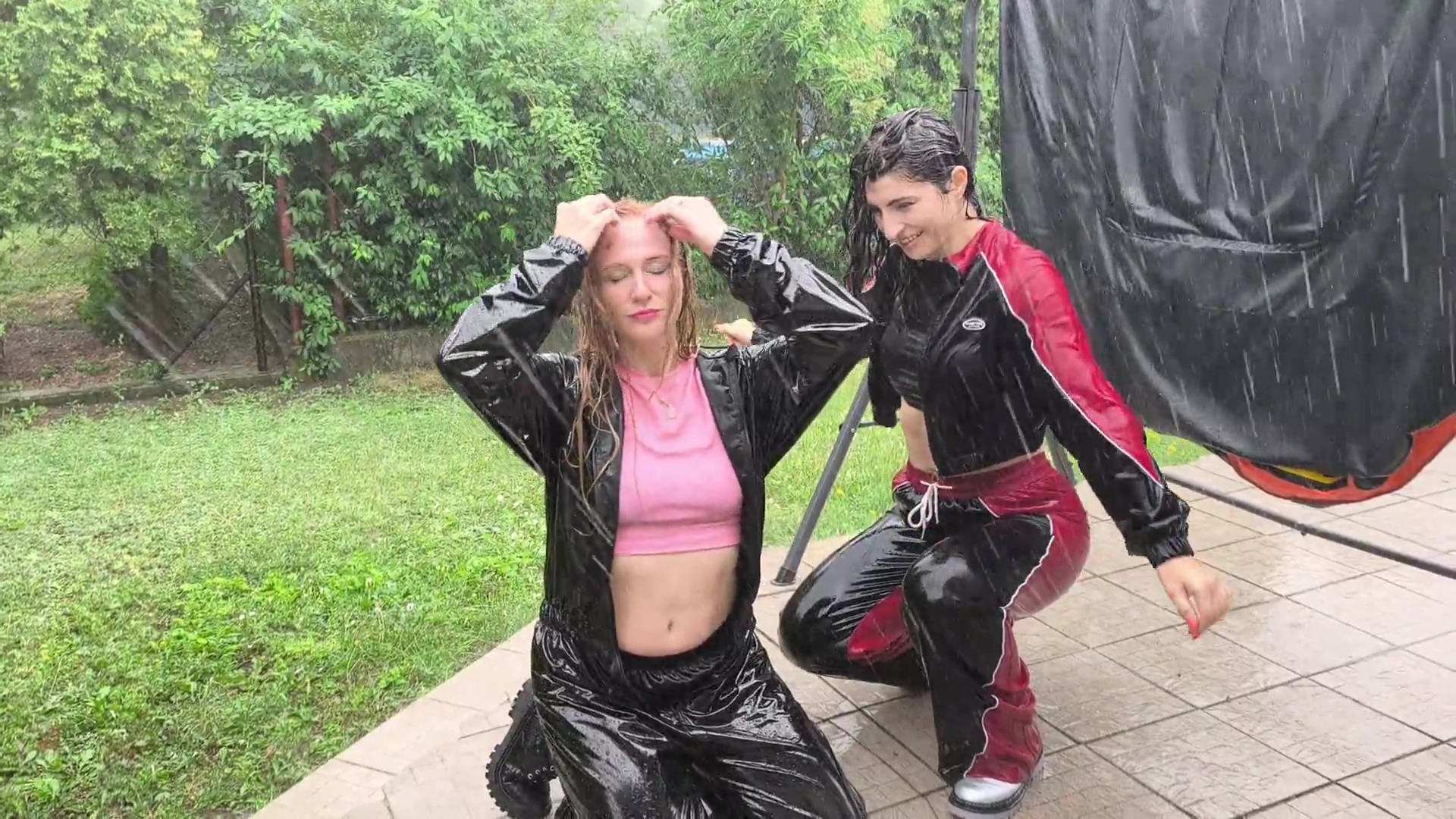 Two girls get very wet in the pouring rain - frame at 8m6s