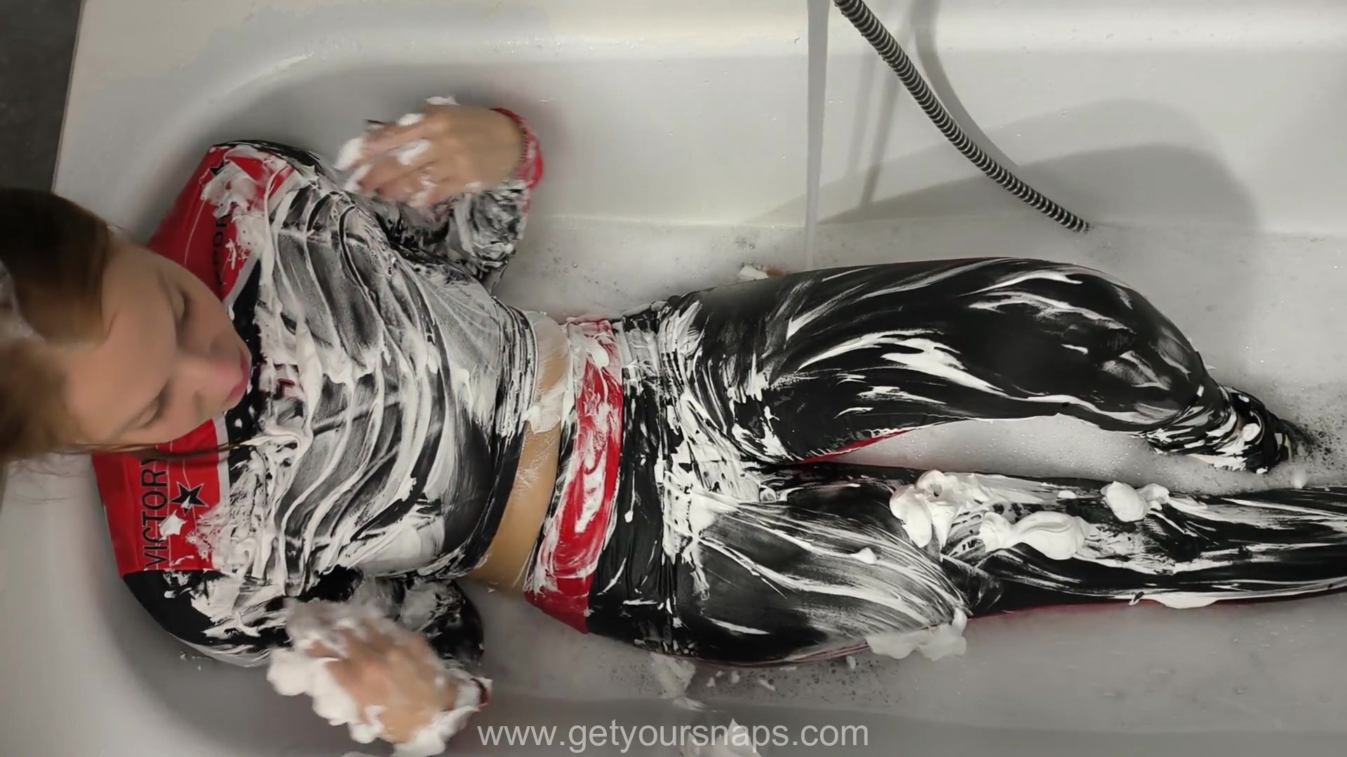 Sarah is showering in sports leggings and a top